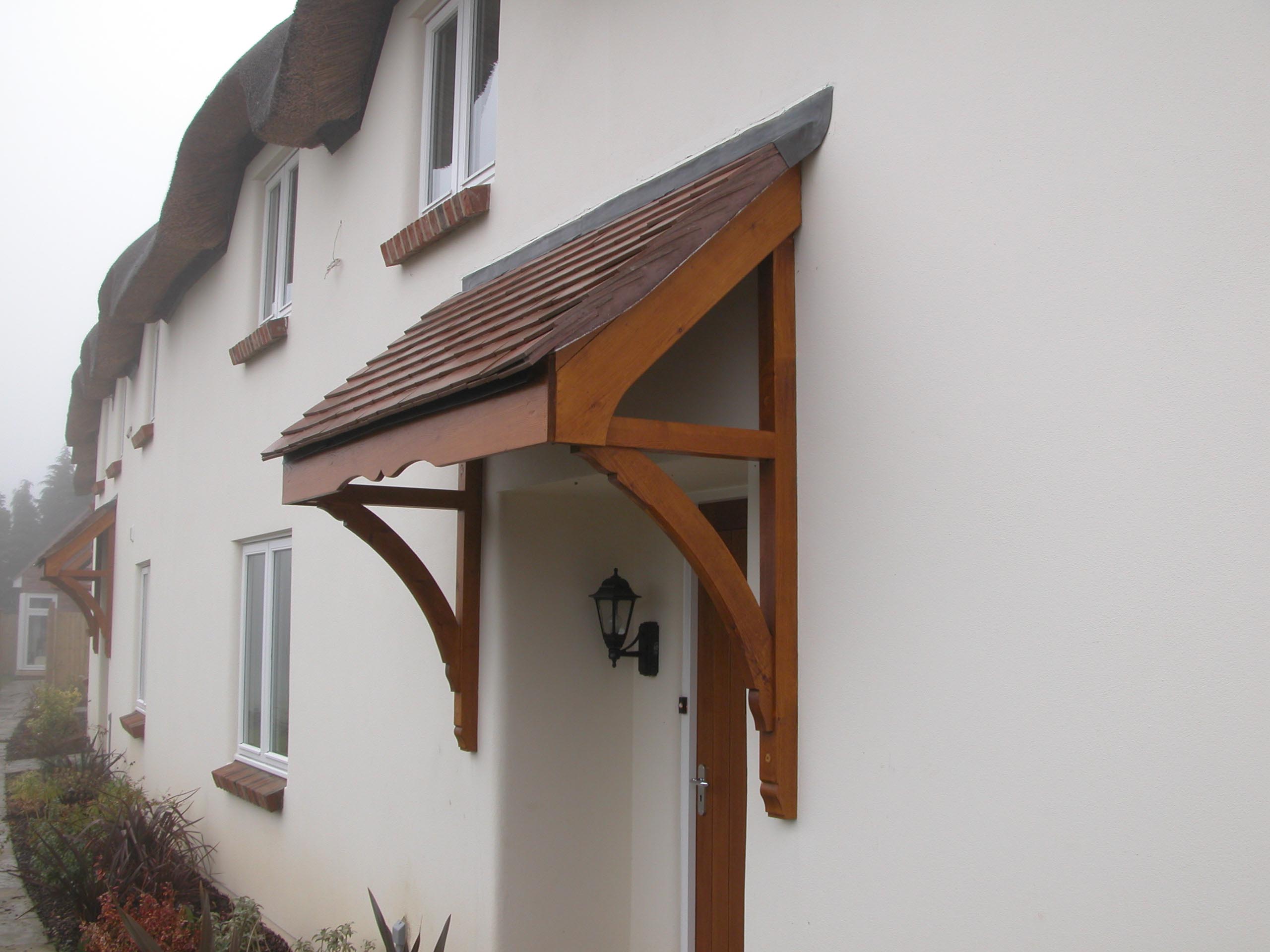 stained timber door canopy